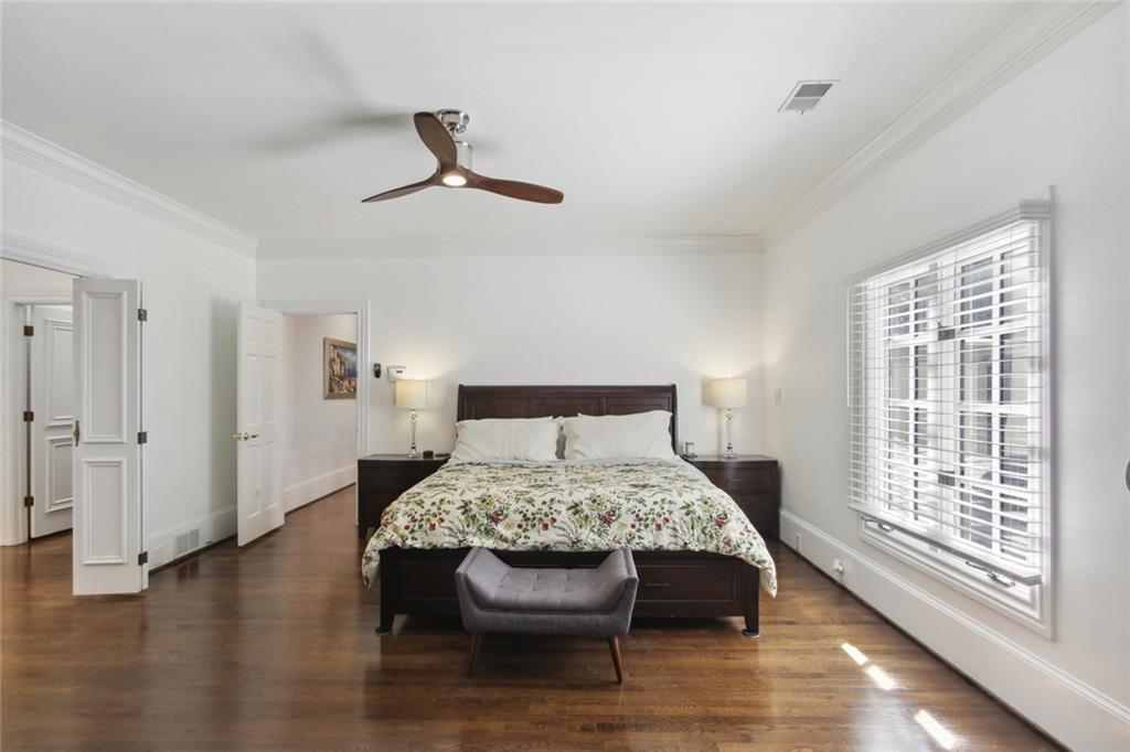 2760 Carmon On Wesley Northwest Atlanta, GA 30327 - Photo 17 of 30 a bed sitting in a bedroom next to a window and a chandelier