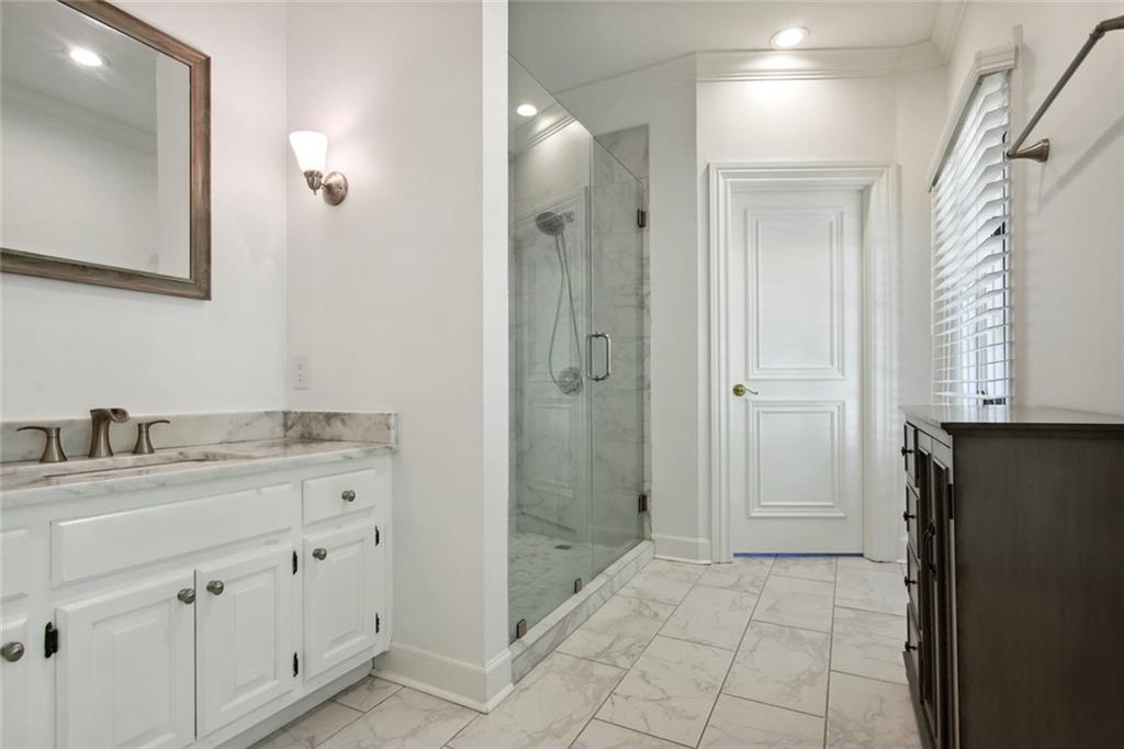 2760 Carmon On Wesley Northwest Atlanta, GA 30327 - Photo 21 of 30 a bathroom with a granite countertop sink a mirror and a shower