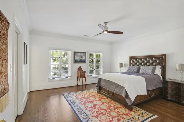 a bedroom with a large bed and a window