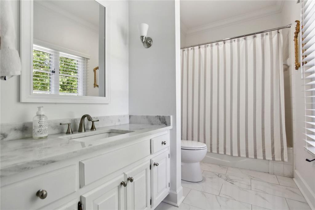 2760 Carmon On Wesley Northwest Atlanta, GA 30327 - Photo 24 of 30 a bathroom with a granite countertop sink a toilet and a mirror