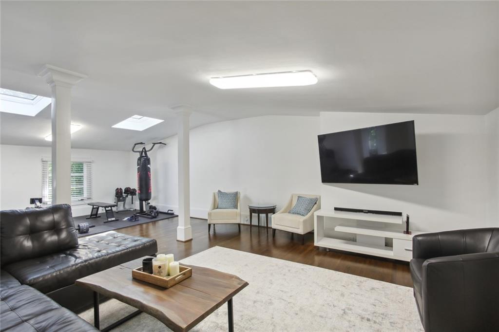 2760 Carmon On Wesley Northwest Atlanta, GA 30327 - Photo 27 of 30 a living room with furniture and a flat screen tv