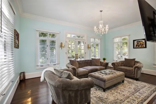 a living room with furniture and a chandelier