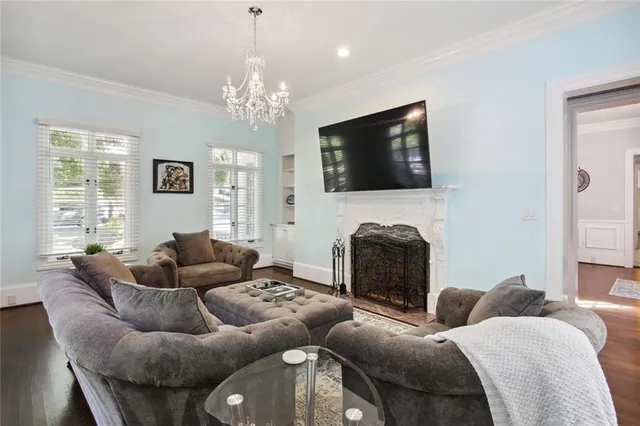 a living room with furniture a fireplace and a flat screen tv
