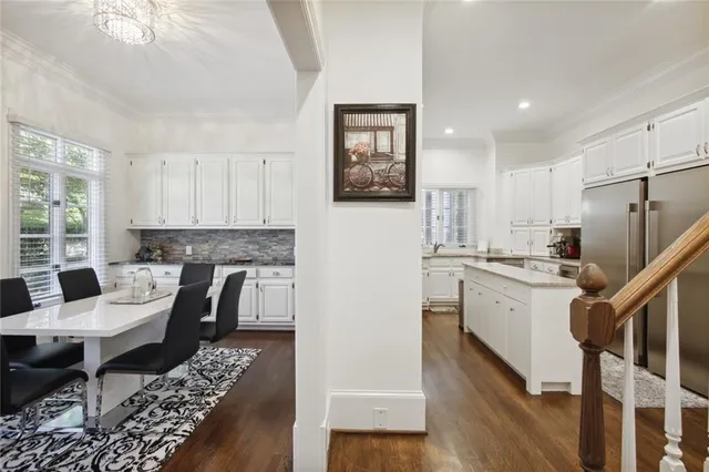 a kitchen with a refrigerator and a stove top oven