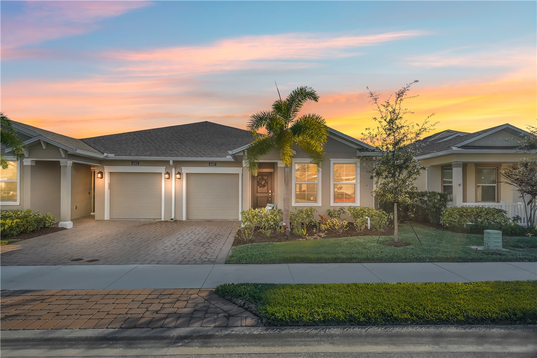 6187 Red Maple Manor Vero Beach, FL 32966 - Photo 2 of 31 front view of a house and a yard