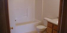 6853 Friday Road Byron, IL 61010 - Photo 2 of 4 a white toilet sitting next to a shower