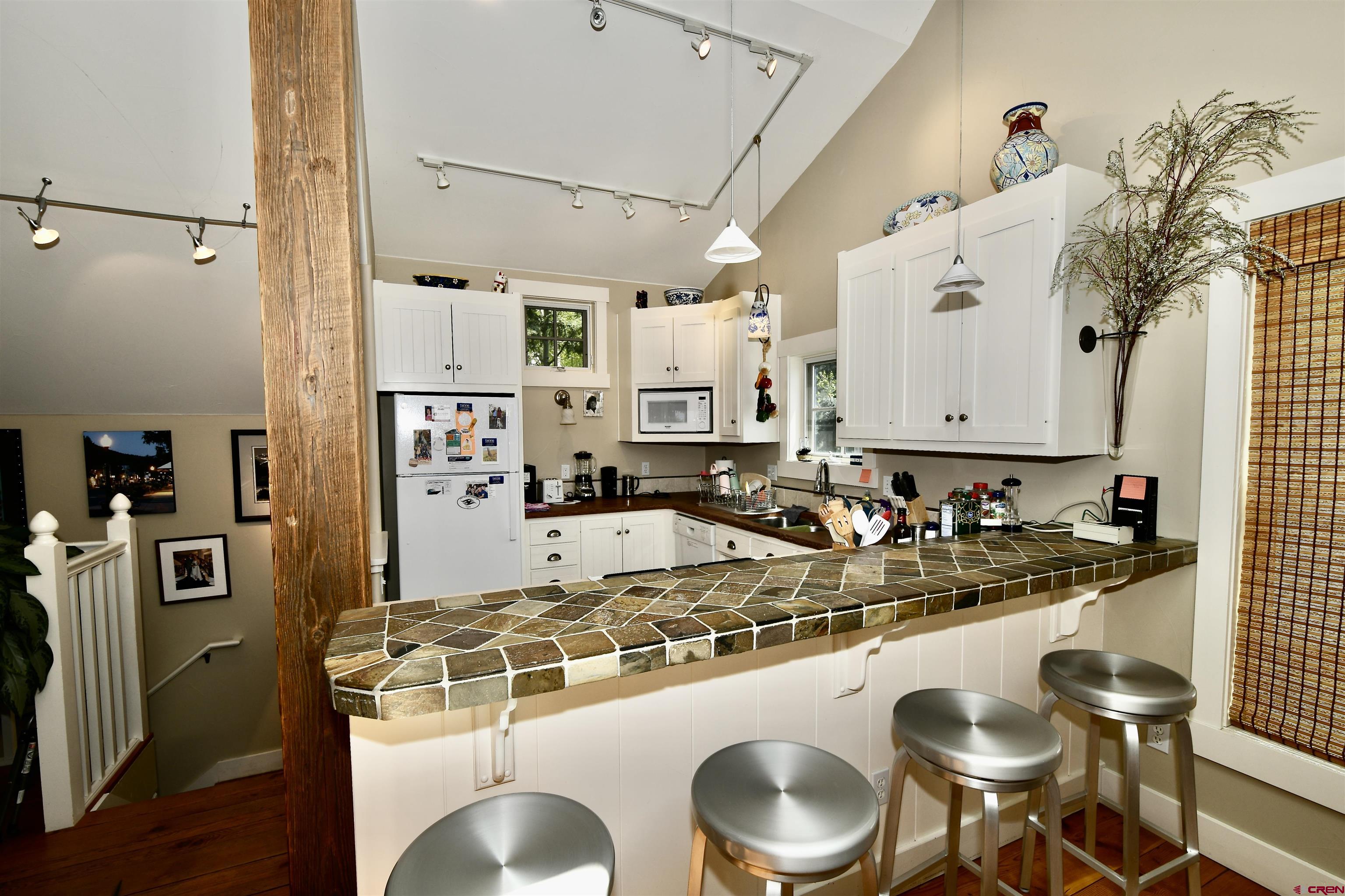 602-604 4th Street Crested Butte, CO 81224 - Photo 13 of 45 a kitchen with a table chairs stove and cabinets