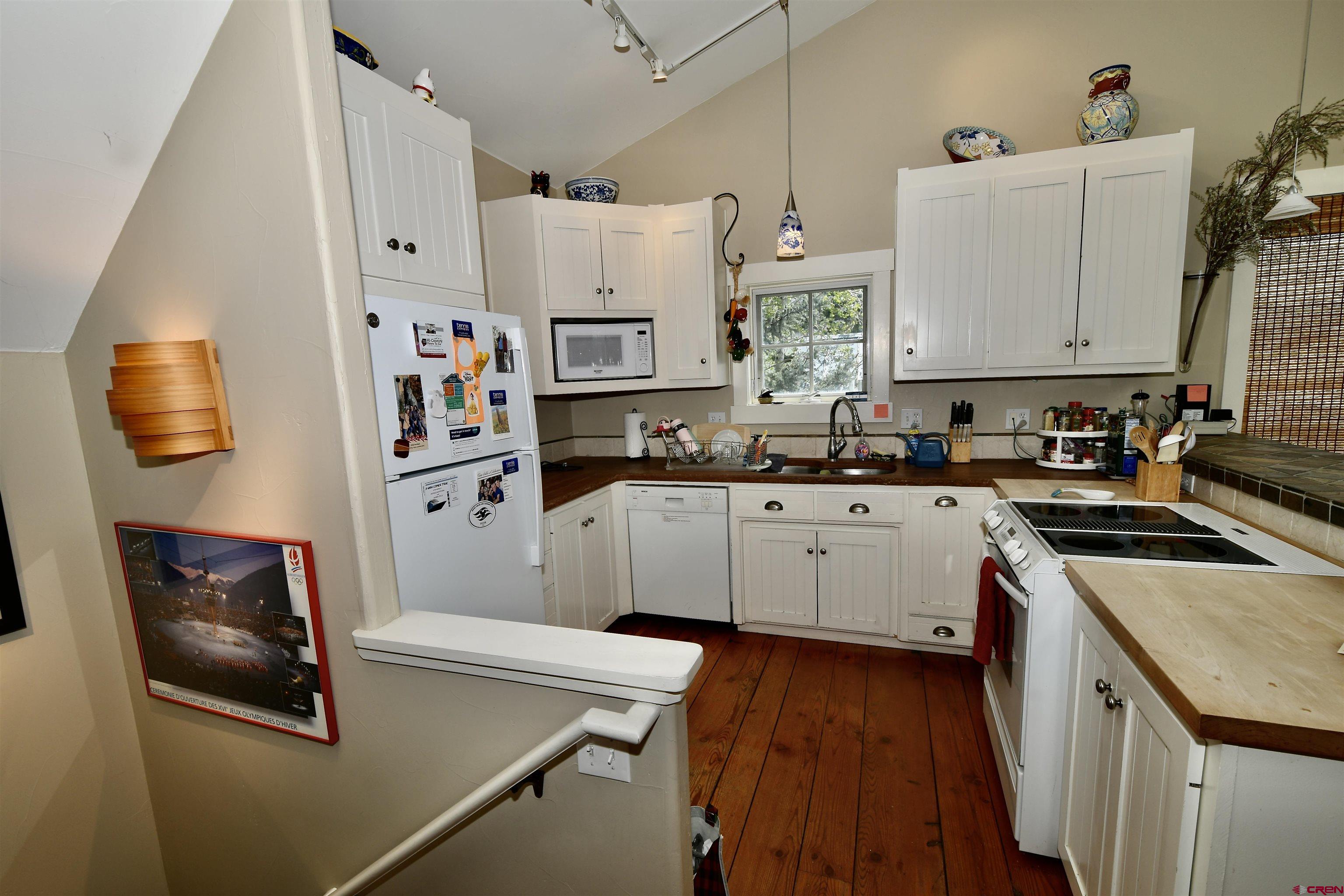 602-604 4th Street Crested Butte, CO 81224 - Photo 14 of 45 a kitchen with stainless steel appliances a stove a sink a refrigerator and cabinets