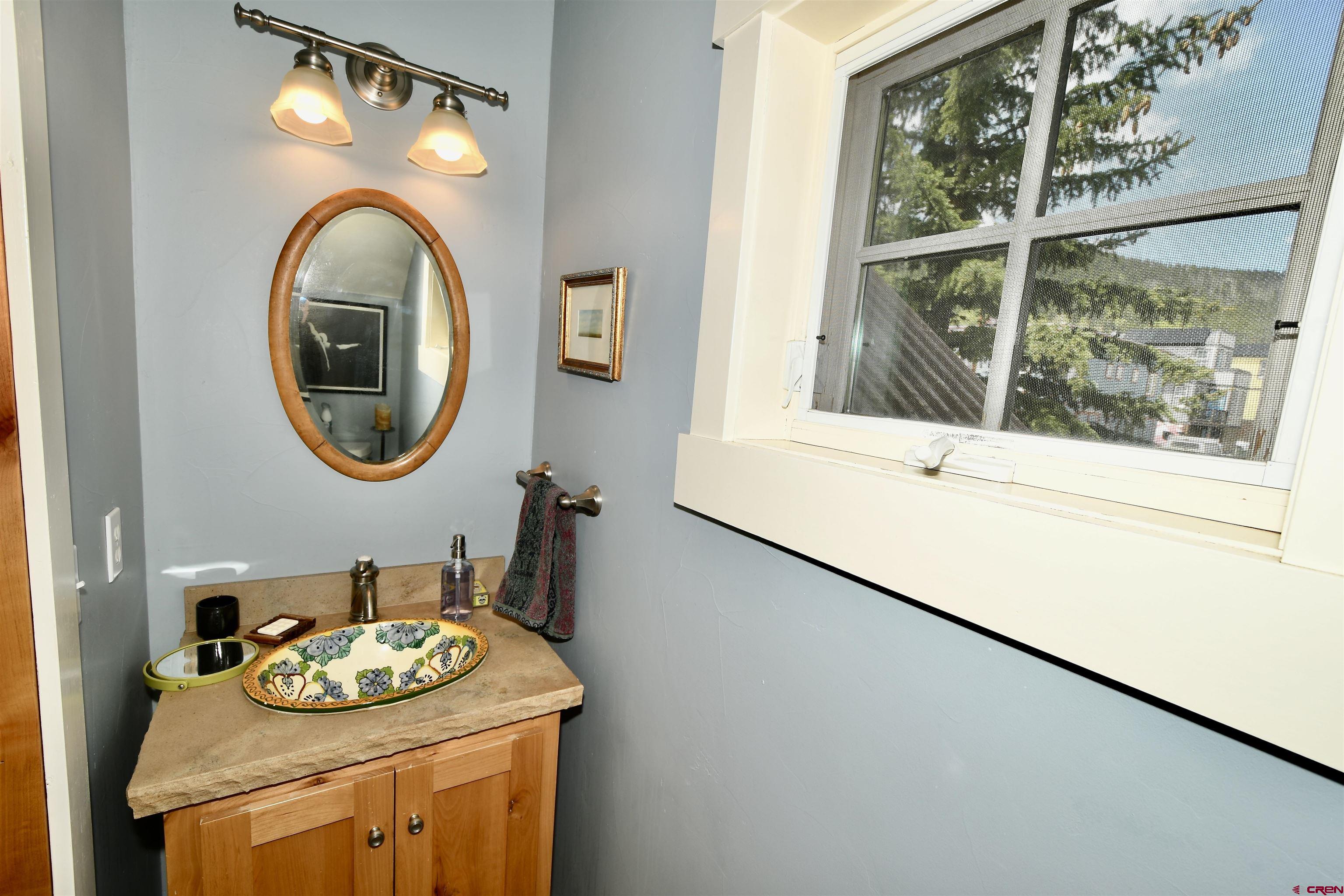 602-604 4th Street Crested Butte, CO 81224 - Photo 15 of 45 a bathroom with a granite countertop sink and a mirror