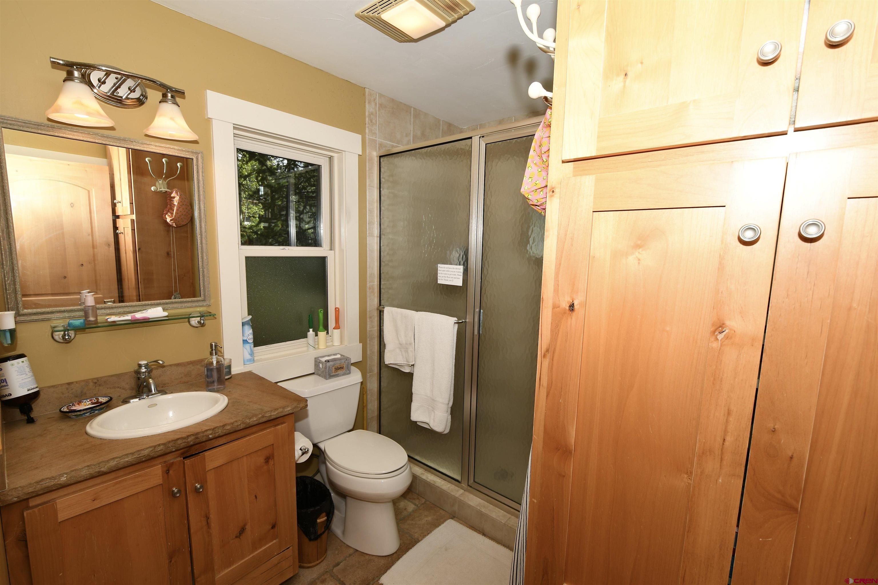 602-604 4th Street Crested Butte, CO 81224 - Photo 17 of 45 a bathroom with a granite countertop sink toilet and shower