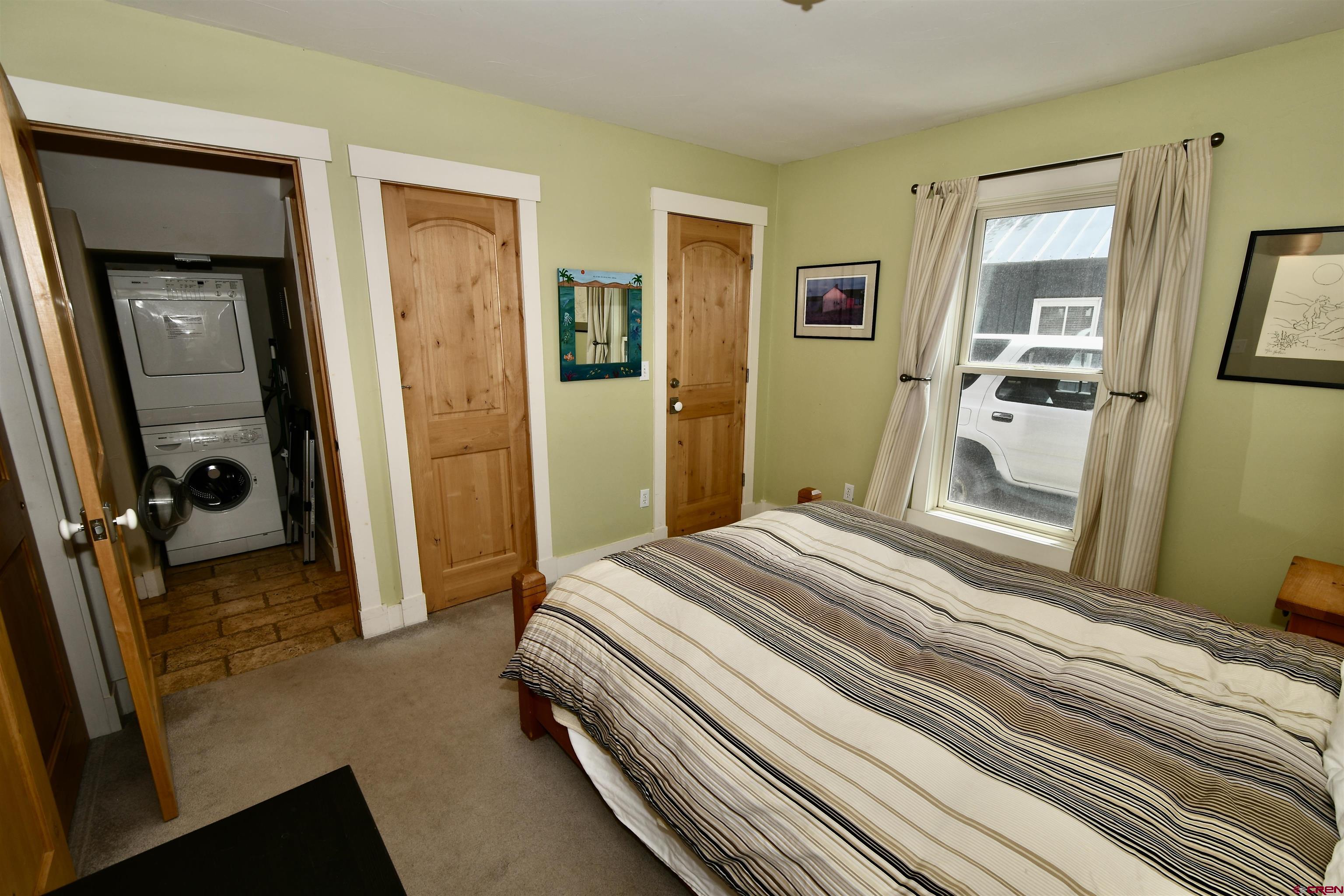 602-604 4th Street Crested Butte, CO 81224 - Photo 19 of 45 a bedroom with a bed and a large mirror in a bedroom