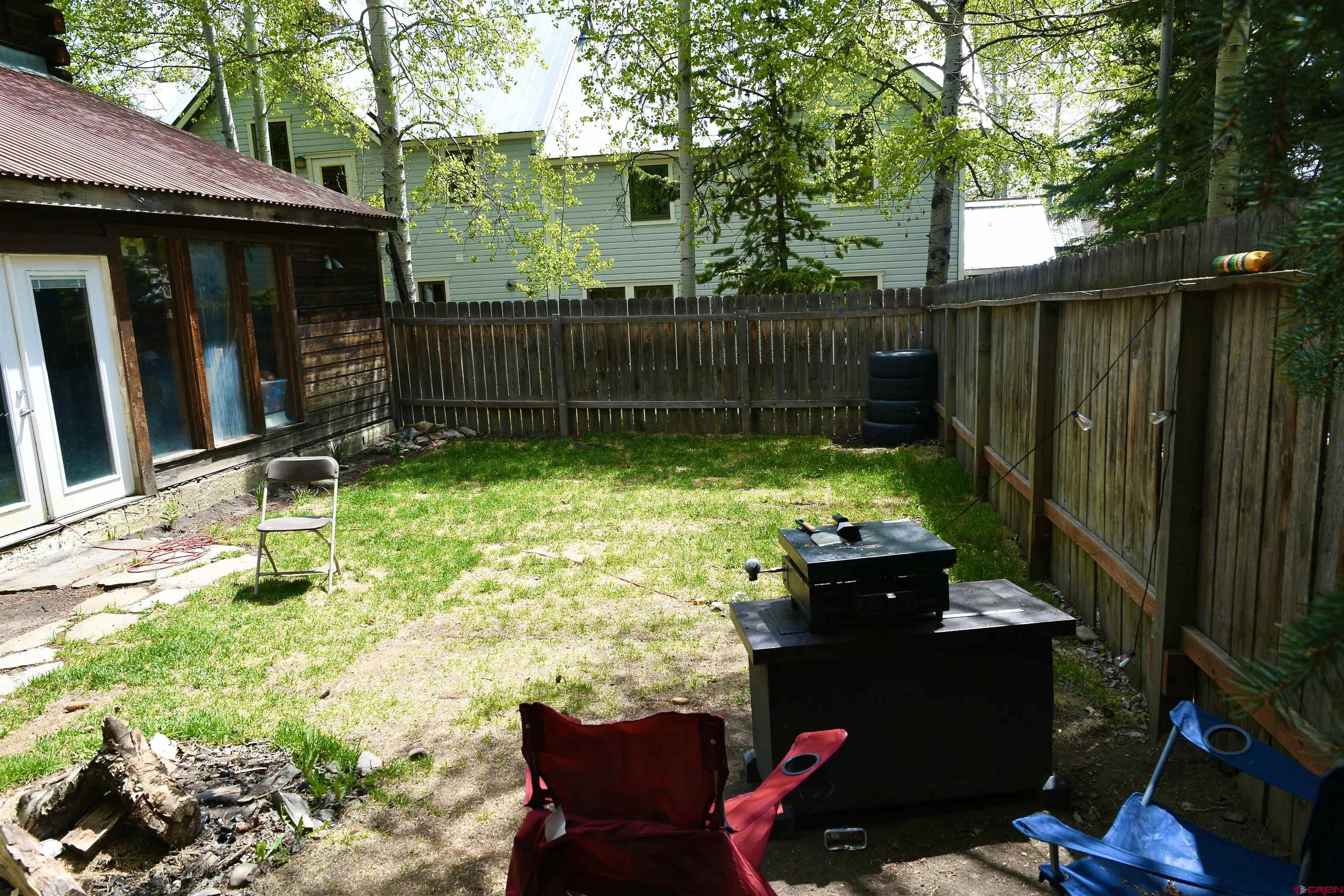602-604 4th Street Crested Butte, CO 81224 - Photo 28 of 45 a backyard of a house with table and chairs