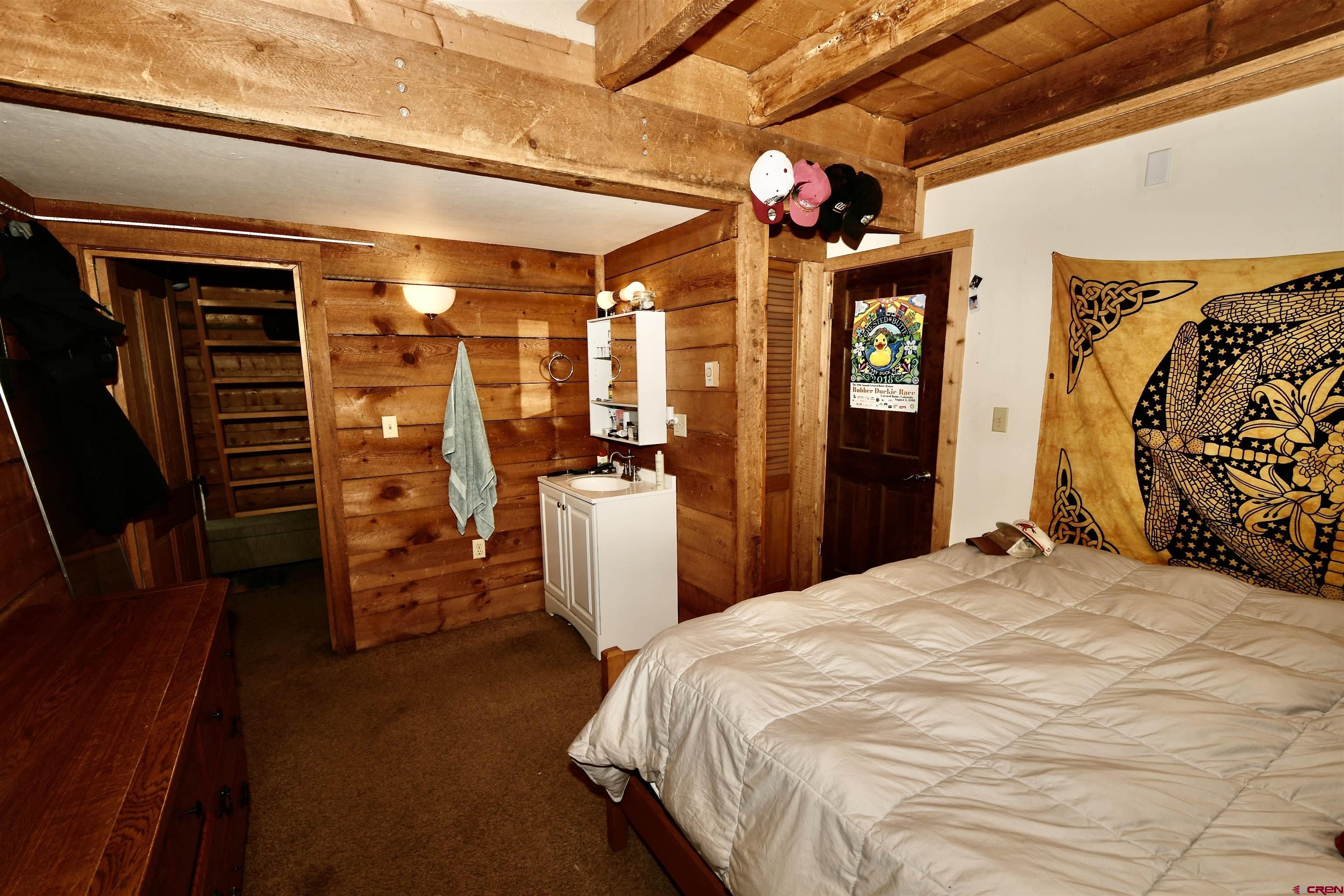 602-604 4th Street Crested Butte, CO 81224 - Photo 40 of 45 a bedroom with a bed and a walk in closet