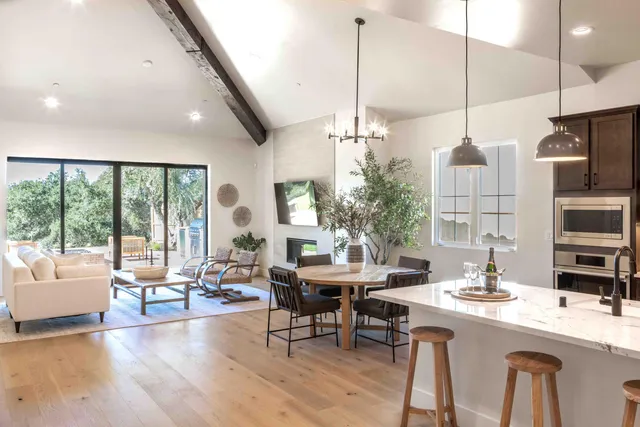 a very nice looking room with a large window and furniture