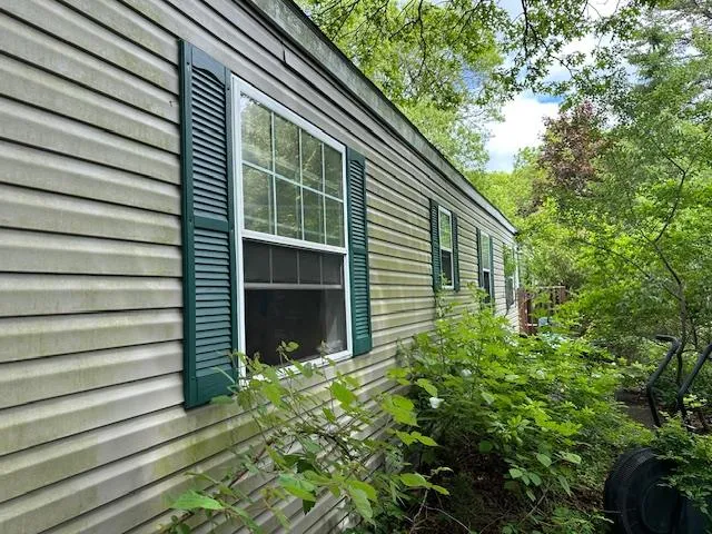a view of house with backyard and garden