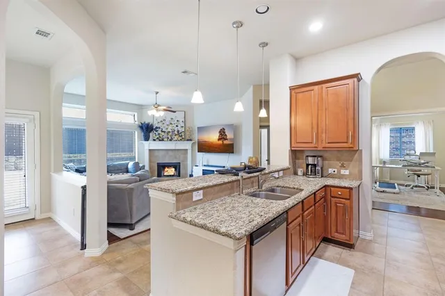 a kitchen with granite countertop a stove oven and cabinets