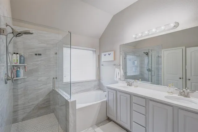 a bathroom with a double vanity sink mirror double and shower