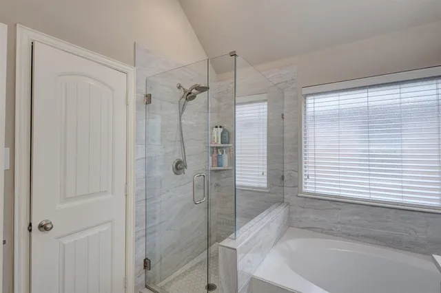 a bathroom with a bathtub and shower