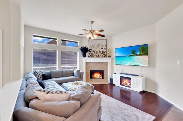 a living room with furniture a fireplace and a flat screen tv