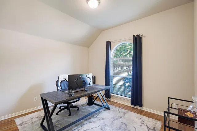 a workspace room with furniture and a window