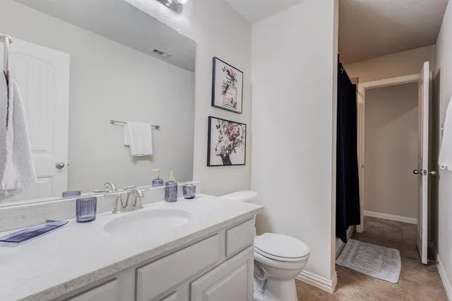 a bathroom with a sink toilet and a mirror
