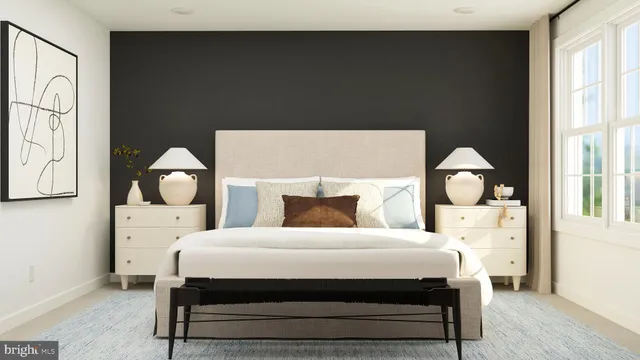 a bedroom with a bed and a painting on the wall