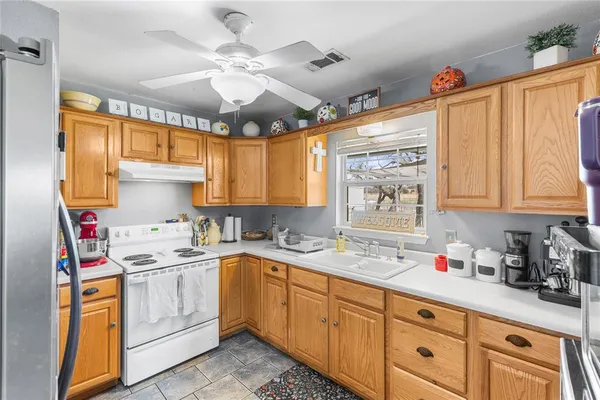a kitchen with stainless steel appliances cabinets a large window and a sink