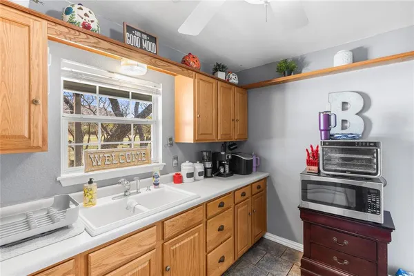 a kitchen with sink cabinets and window