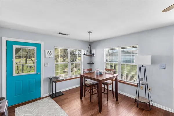 a dining room with furniture and wooden floor