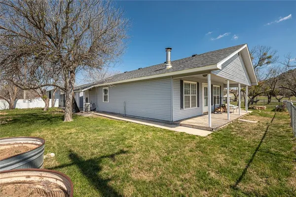 a backyard of a house with table and chairs