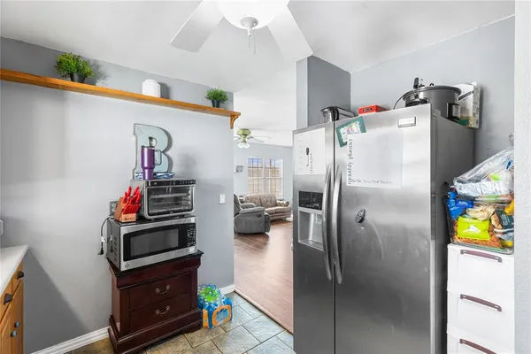 a kitchen with refrigerator and window