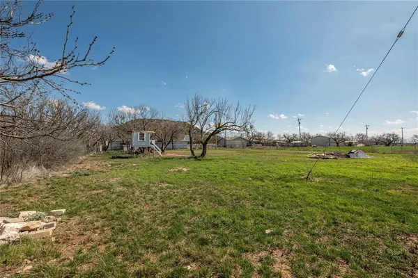 a view of an house with backyard space and balcony