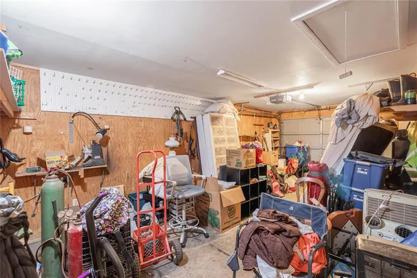 a view of a hallway with wooden floor and a bathroom