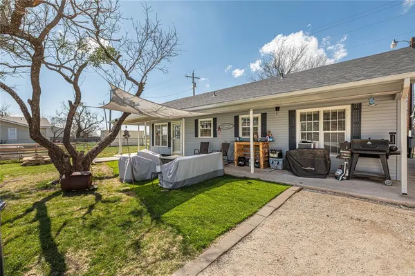 a view of a house with backyard porch and sitting area