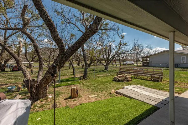 a backyard of a house with barbeque oven
