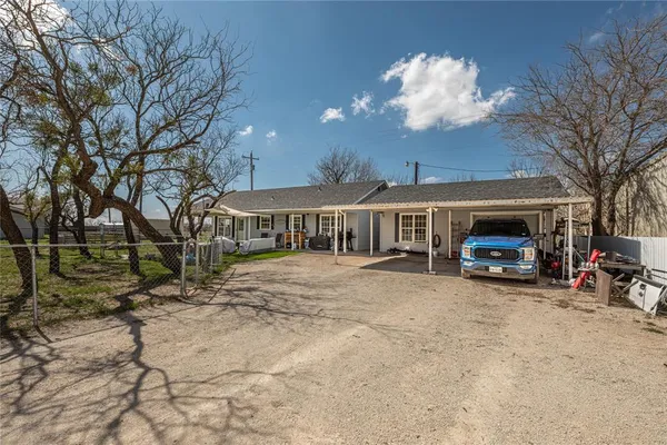 a view of a house with cars parked in front of it
