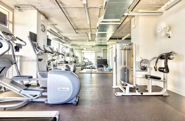 a living room with lots of furniture and a wooden floor