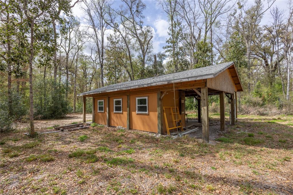 1187 Boston Road Fort White, FL 32038 - Photo 3 of 26 a view of a house with backyard and trees