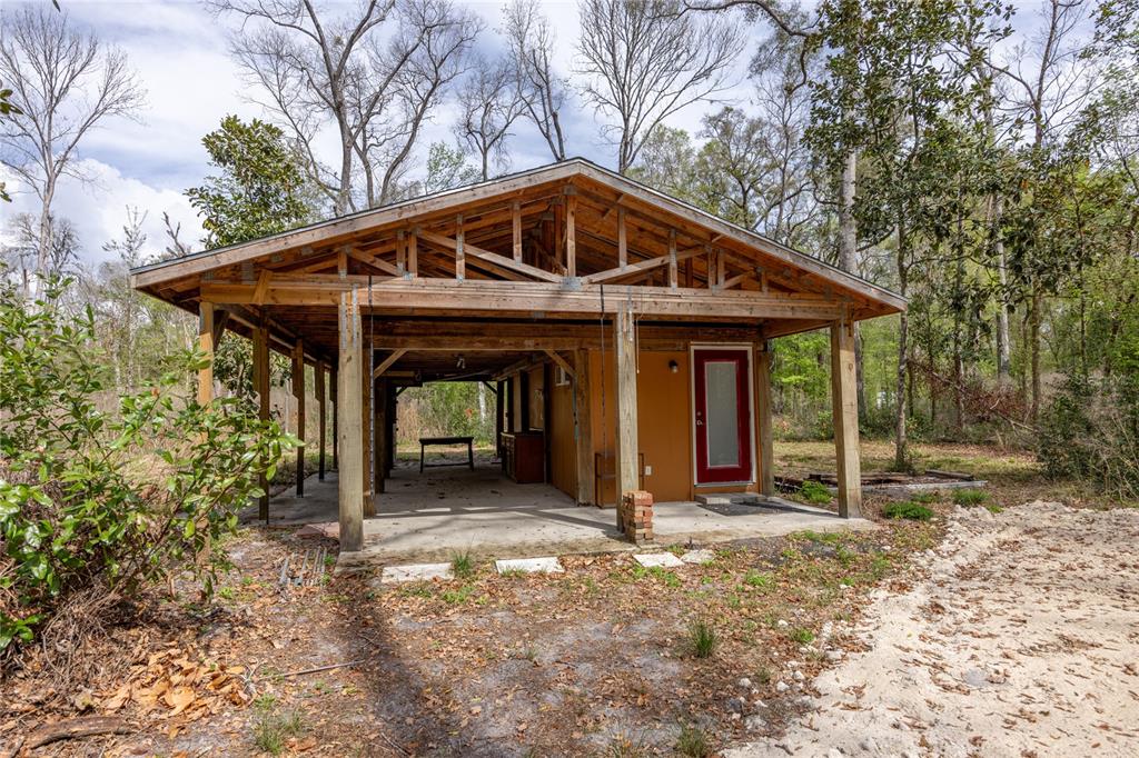 1187 Boston Road Fort White, FL 32038 - Photo 5 of 26 a front view of a house with garden