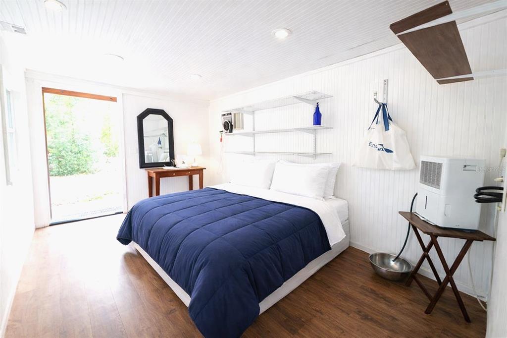 1187 Boston Road Fort White, FL 32038 - Photo 8 of 26 a bedroom with a bed a mirror and a window