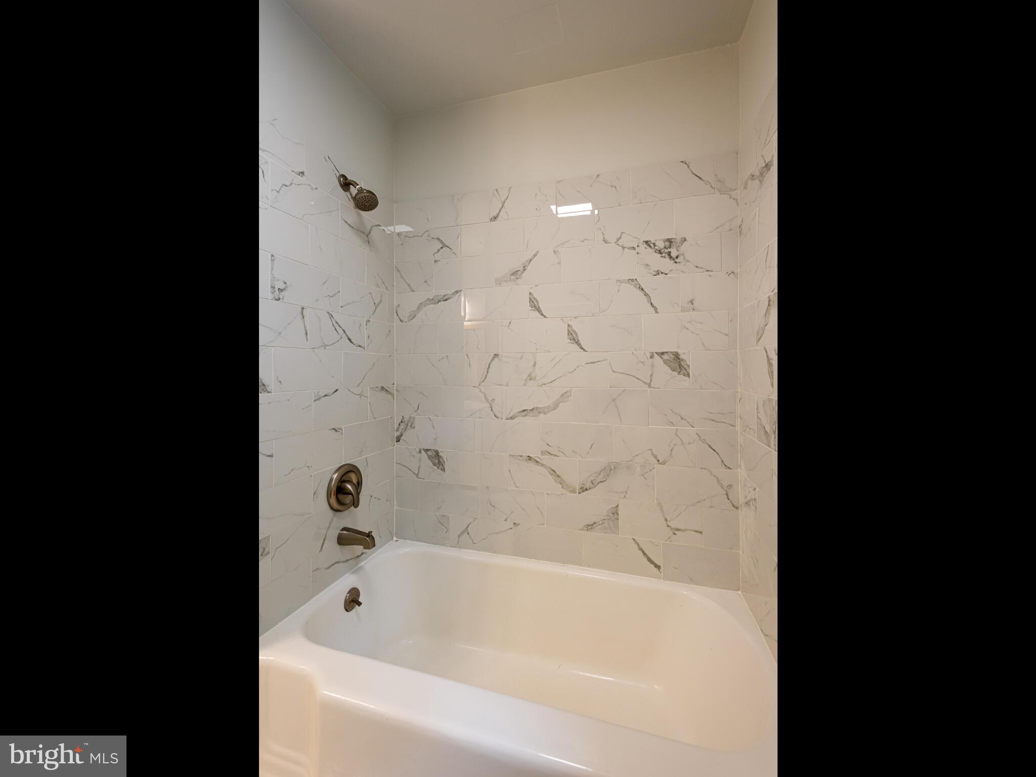 191 West Street Road Kennett Square, PA 19348 - Photo 20 of 41 a bathroom with a bathtub and shower