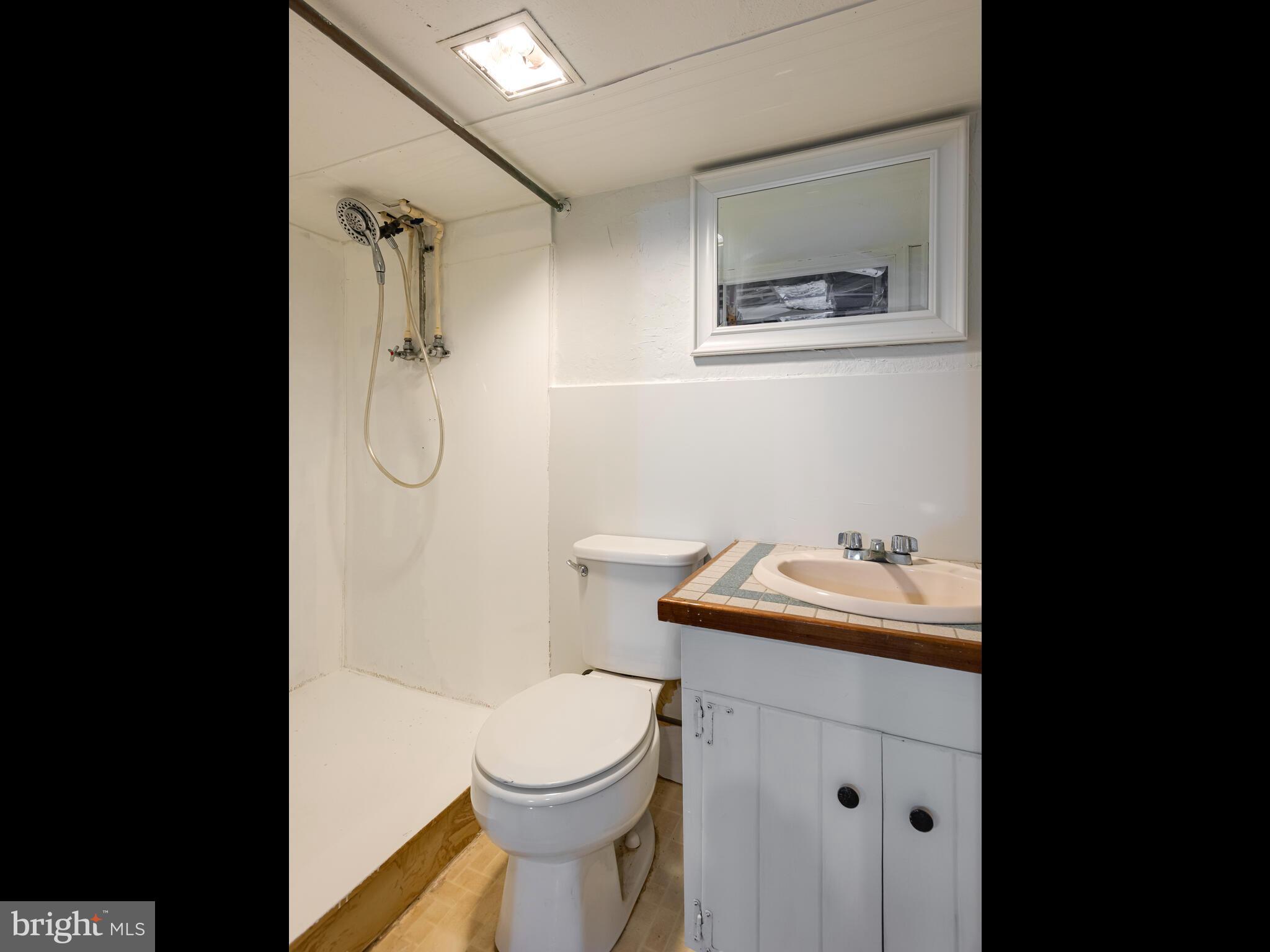 191 West Street Road Kennett Square, PA 19348 - Photo 21 of 41 a bathroom with a toilet sink vanity granite and shower