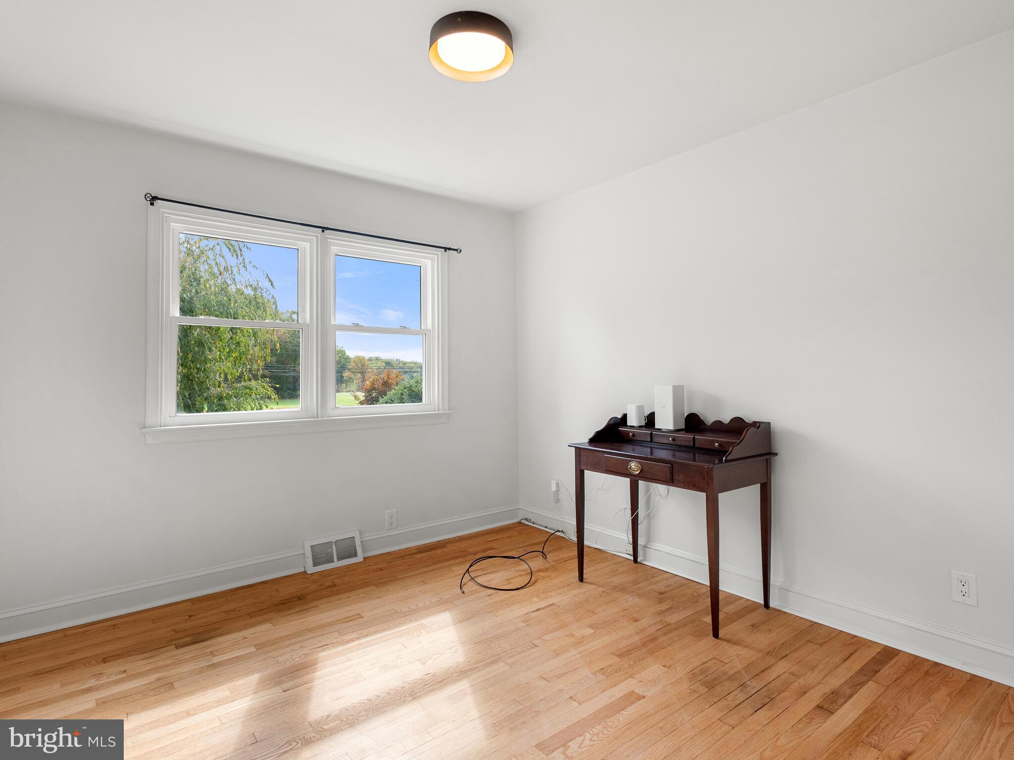 191 West Street Road Kennett Square, PA 19348 - Photo 22 of 41 a view of a room with wooden floor and windows