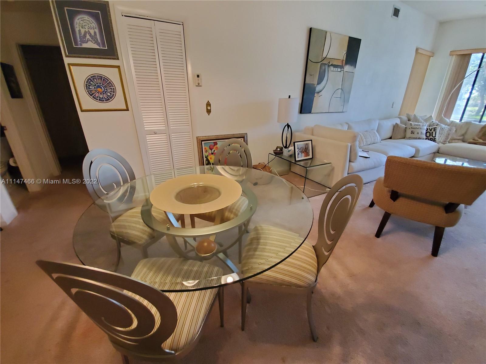 7472 La Paz Boulevard, Unit 104 Boca Raton, FL 33433 - Photo 12 of 44 a room with furniture and a mirror