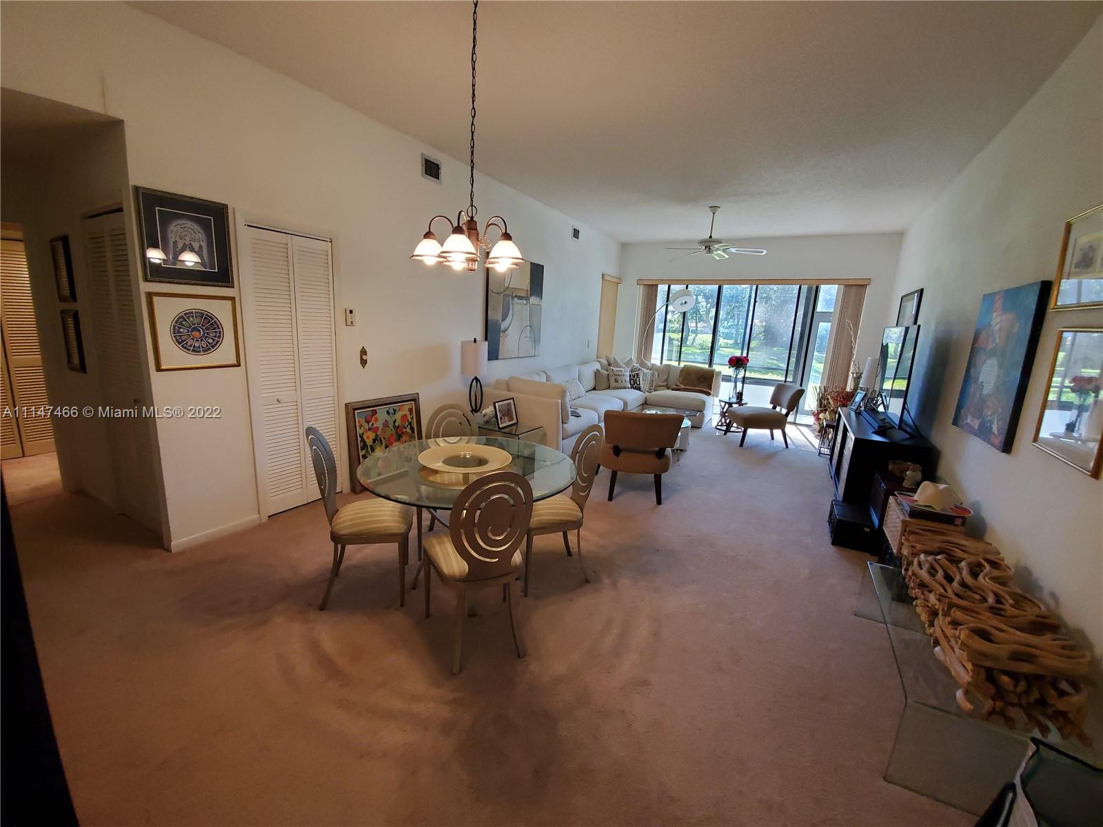 7472 La Paz Boulevard, Unit 104 Boca Raton, FL 33433 - Photo 15 of 44 a view of a livingroom with furniture window and wooden floor