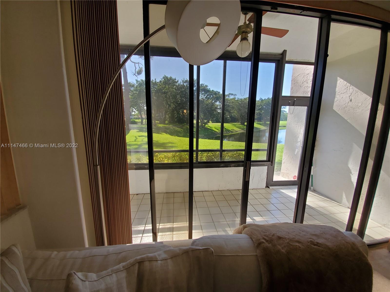 7472 La Paz Boulevard, Unit 104 Boca Raton, FL 33433 - Photo 21 of 44 a bedroom with a bed and a window