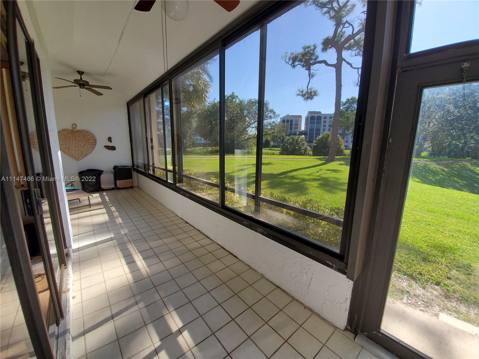 7472 La Paz Boulevard, Unit 104 Boca Raton, FL 33433 - Photo 22 of 44 a view of a porch with wooden floor and outdoor space