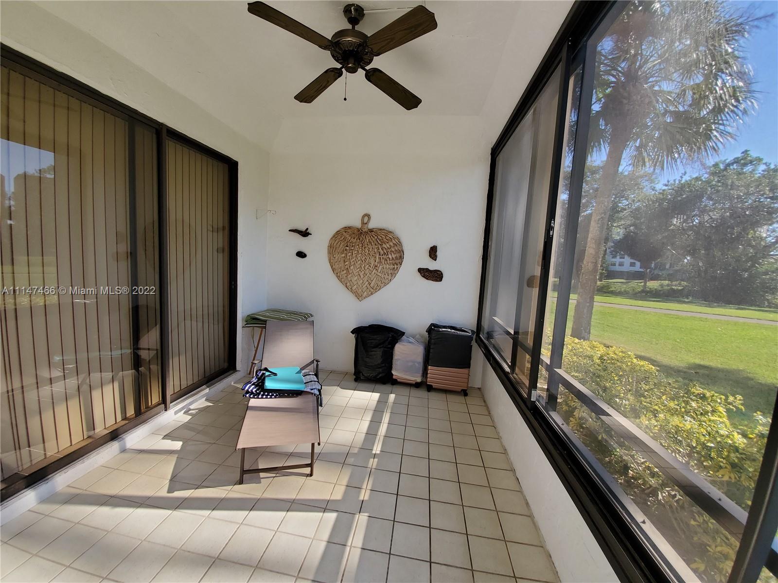 7472 La Paz Boulevard, Unit 104 Boca Raton, FL 33433 - Photo 23 of 44 a living room with couch