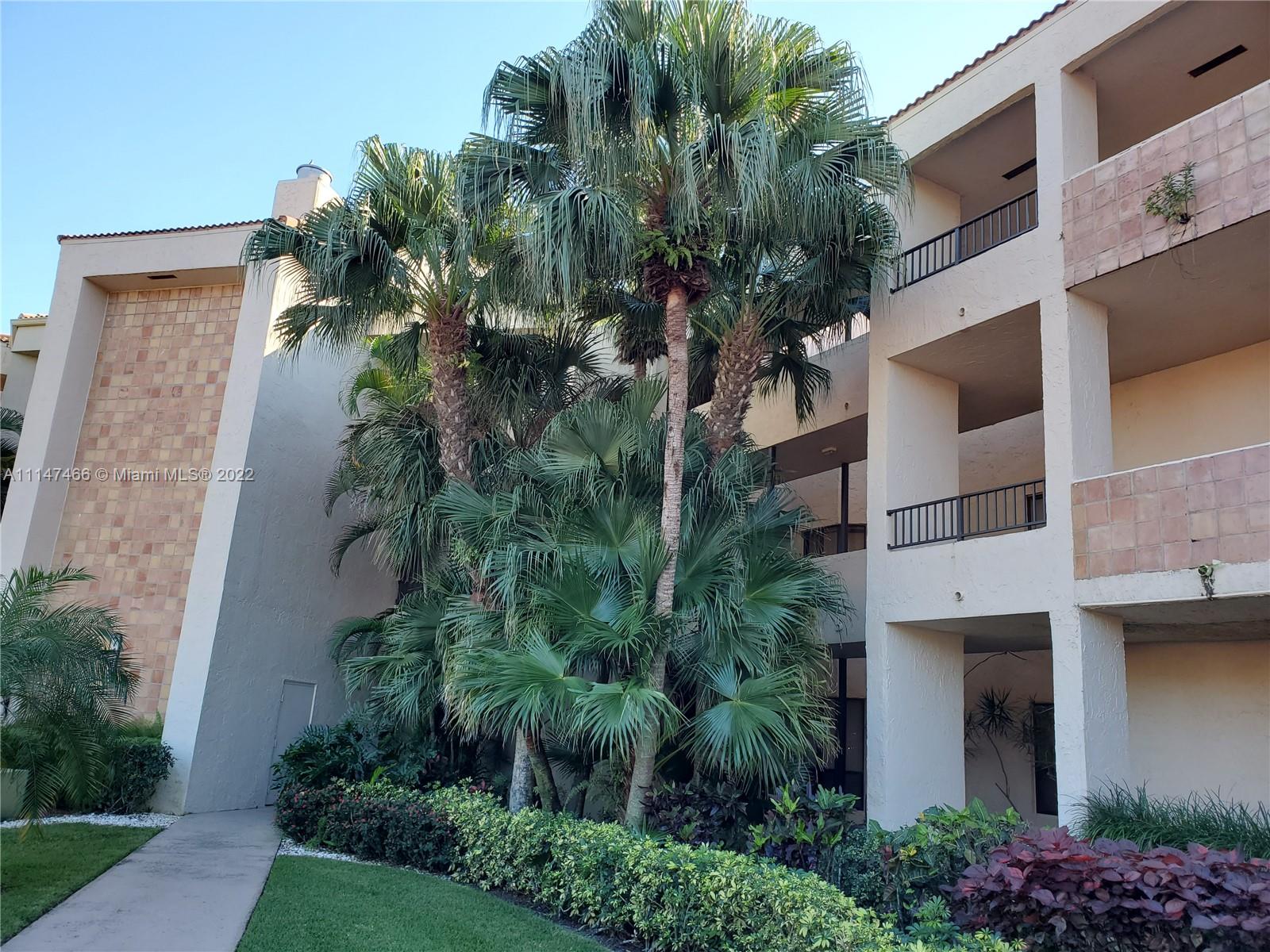 7472 La Paz Boulevard, Unit 104 Boca Raton, FL 33433 - Photo 3 of 44 a plant that is on a brick building