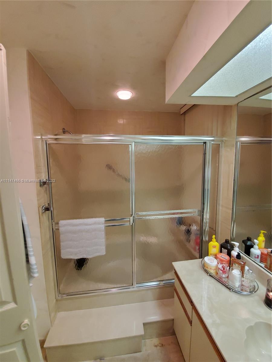 7472 La Paz Boulevard, Unit 104 Boca Raton, FL 33433 - Photo 33 of 44 a bathroom with a shower and a sink